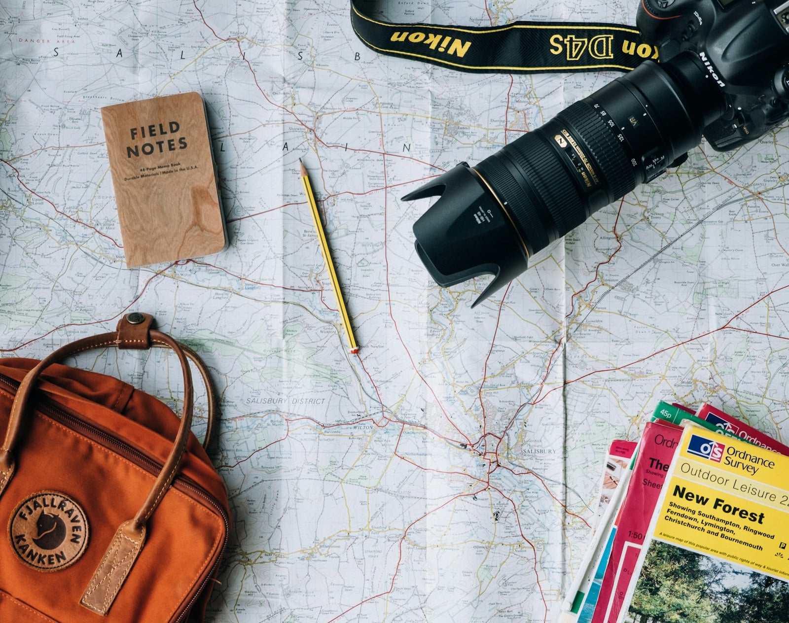 Travel planning desk with map, notebook, and camera
